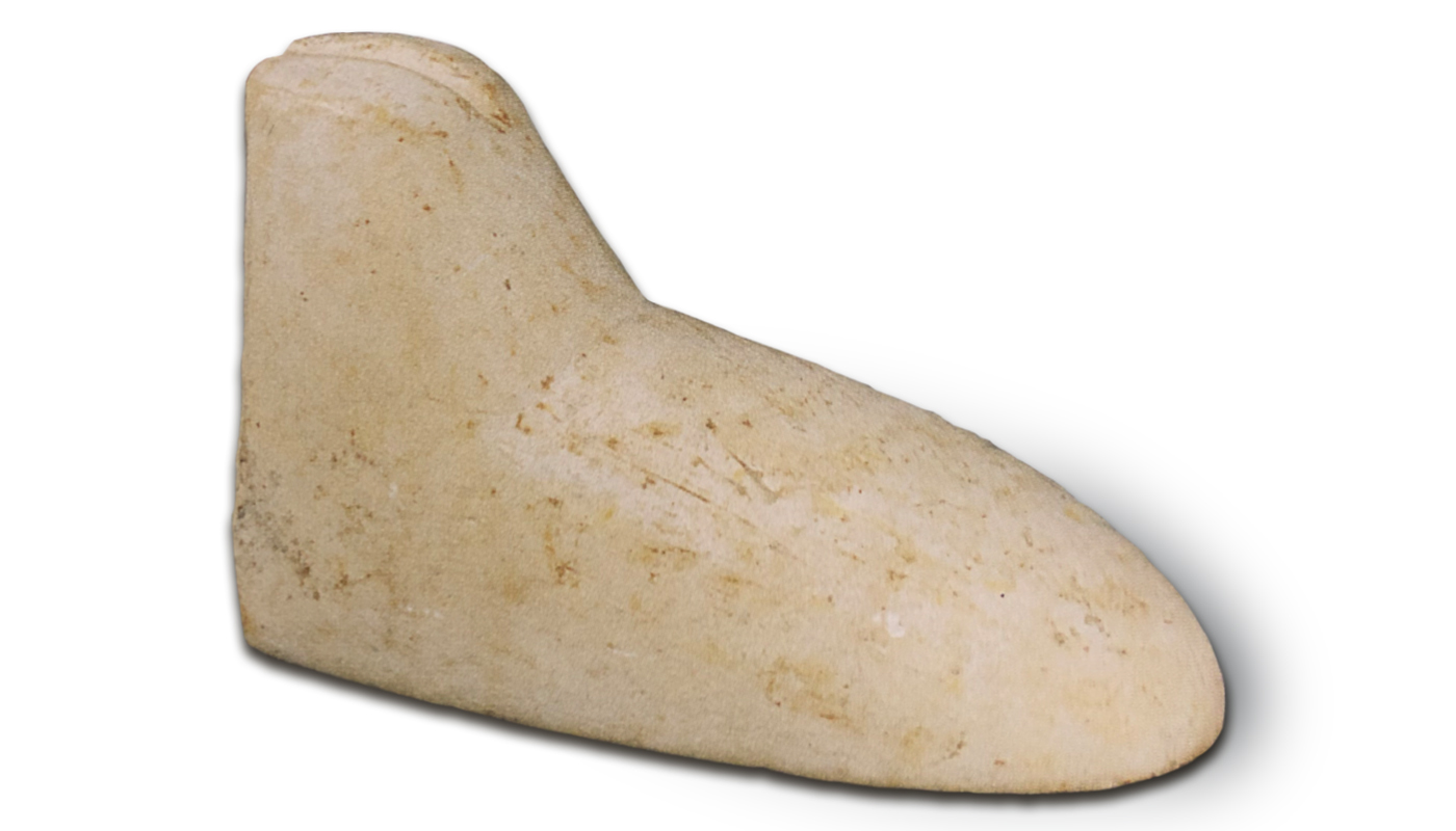 Limestone shoe mold, Neolithic period, Tell Halula, Syria, c.5500 BC. Example of early leatherworking. National Museum of Damascus, inv. DAMASCUS 1397 (HL 46.281).