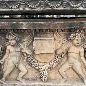 Limestone sarcophagus with pitched roof lid, erotes, garland, Medusa heads, and Greek inscription for Publius Caienius Livianus. Rastan (Arethusa), Syria, 2nd–3rd century CE. National Museum of Damascus.